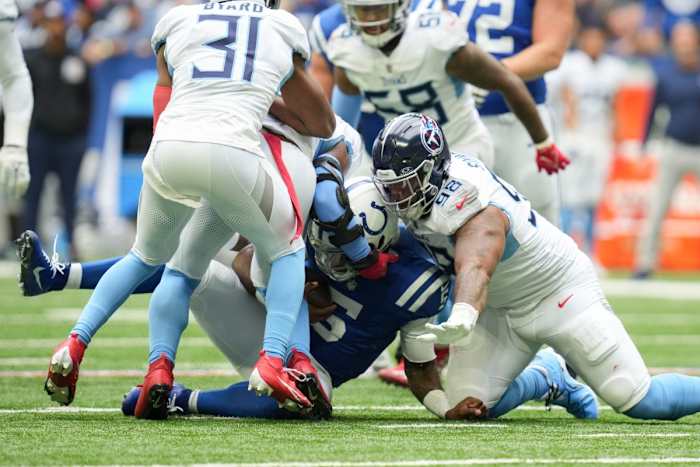 Indianapolis Colts quarterback Anthony Richardson (5) is brought down a slew of defenders including Tennessee Titans defensive tackle Jeffery Simmons (98) and Tennessee Titans safety Kevin Byard (31) on Sunday, Oct. 8, 2023, during a game against the Tennessee Titans at Lucas Oil Stadium in Indianapolis.